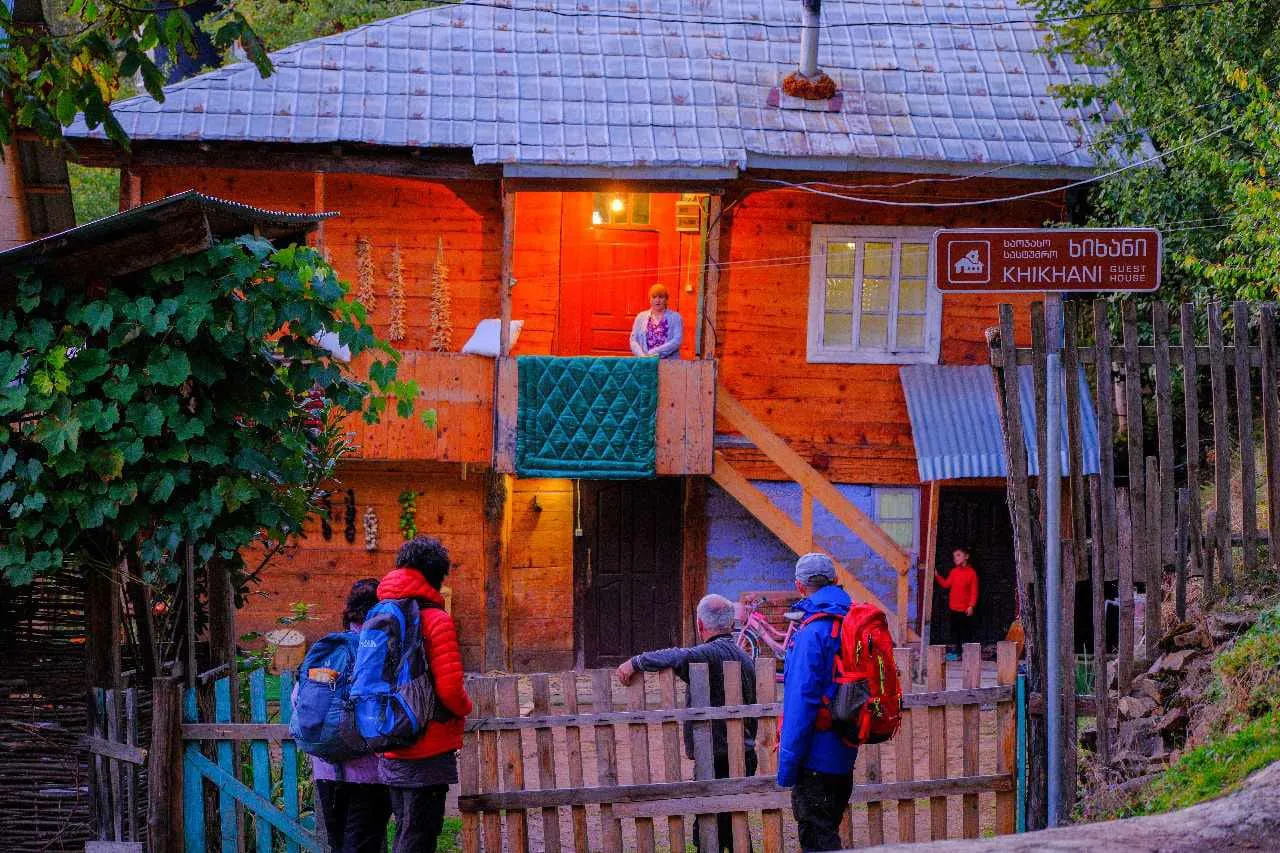The wooden Guest House Khikhani in Khikhadziri with its sign by the gate