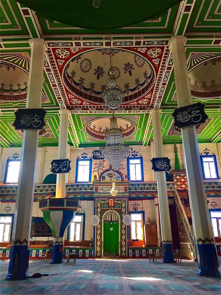 The painted interior of the Khulo mosque with chandeliers