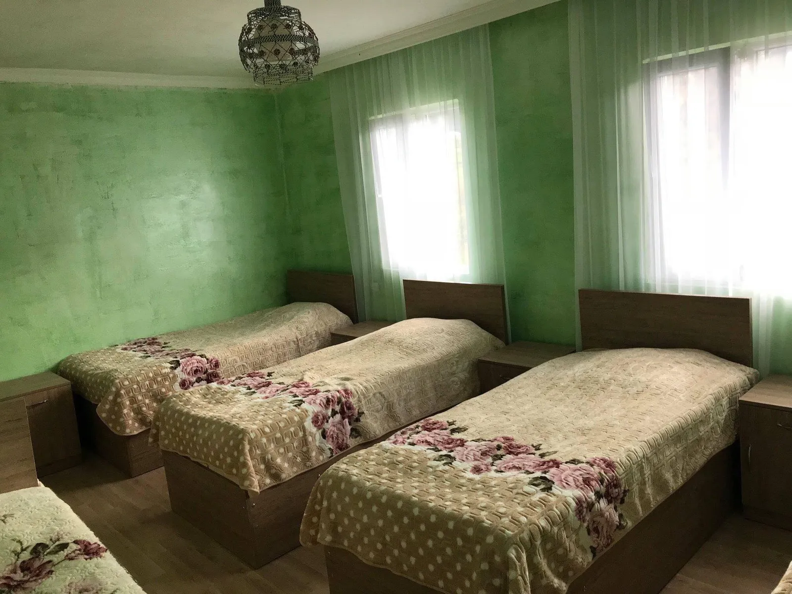 A room with three single beds at Guest House Luka