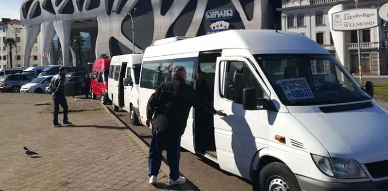 White marshrutka minibuses waiting at the Batumi bus station