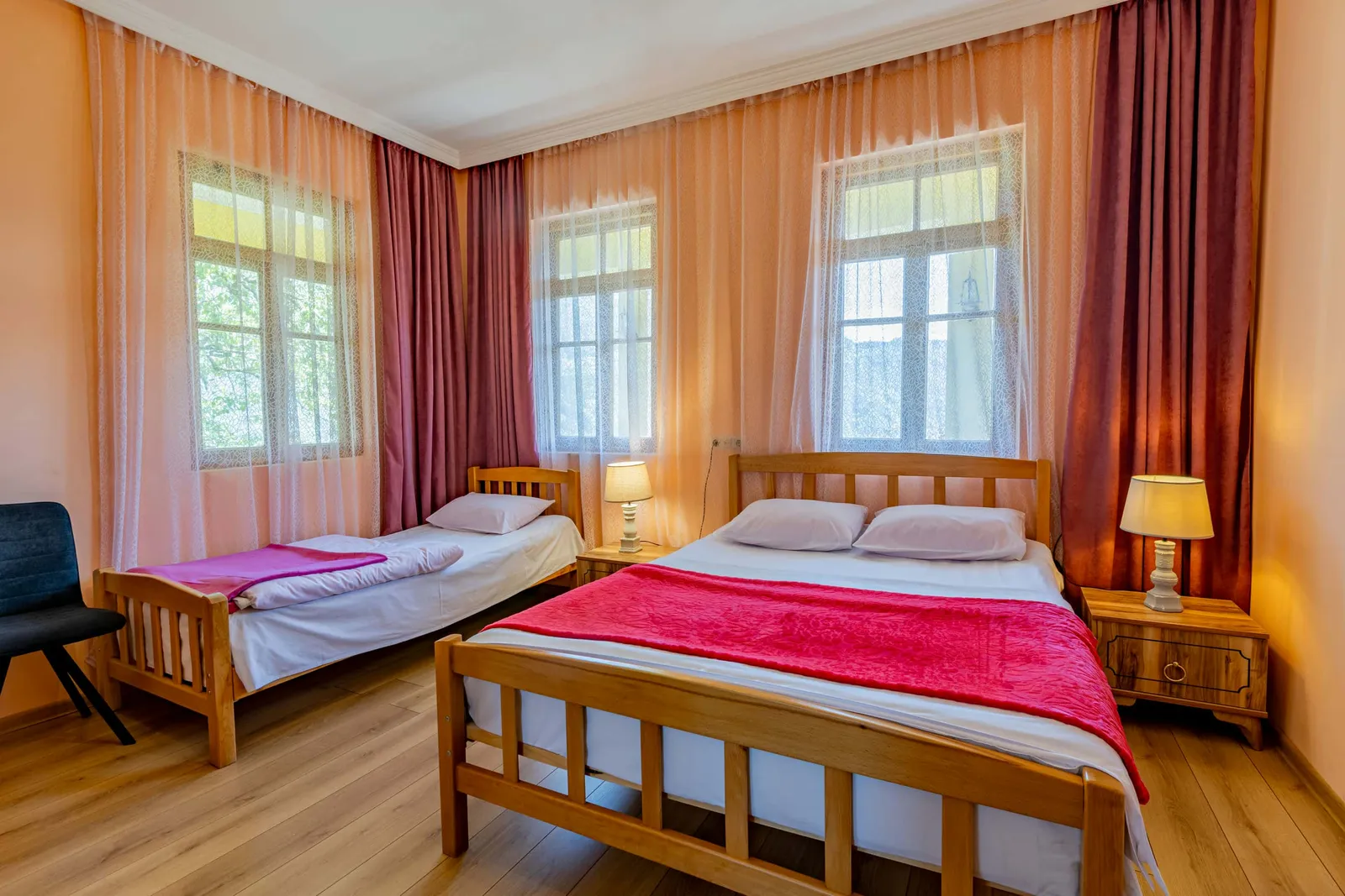 A bright guest room with two beds at Rima's Village Home in Vashlovani