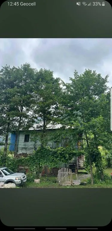 The house of Guest house welcome in Village Tago, with trees and a car parked in front