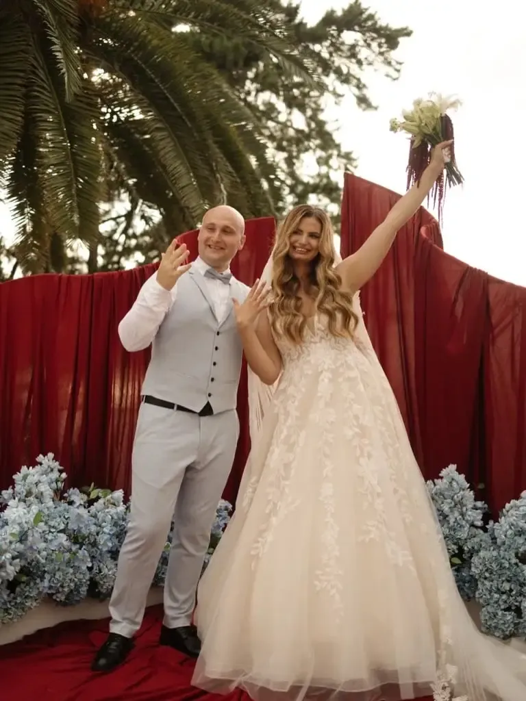 A newly married couple celebrating at a ceremony hosted by Marina Nedvizhenko