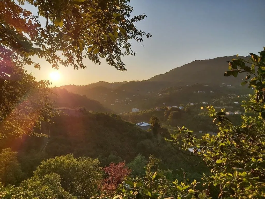 Sunset over the forested hills of Mtirala national park seen from Mtirala House