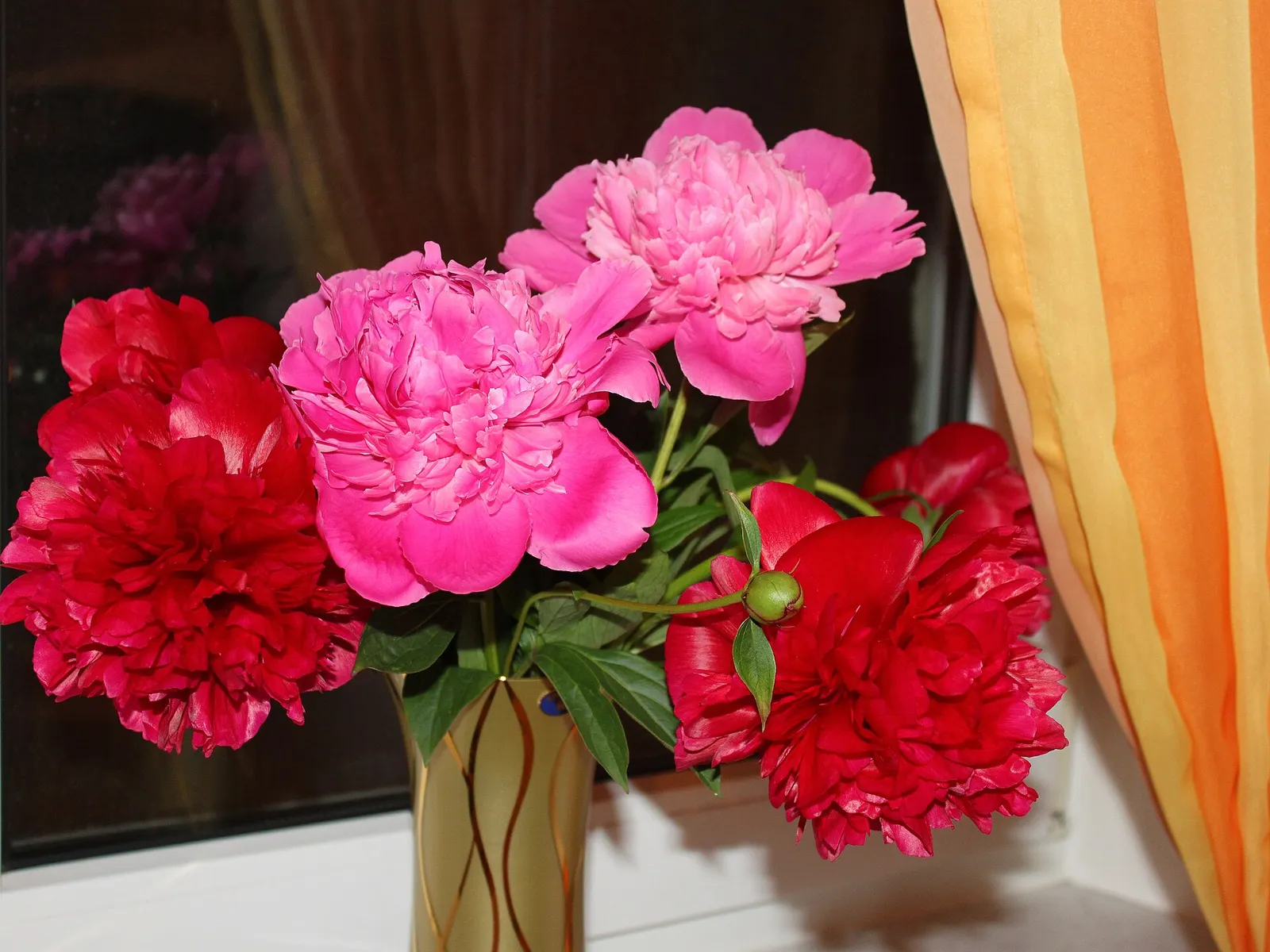 A bouquet of pink and white peonies