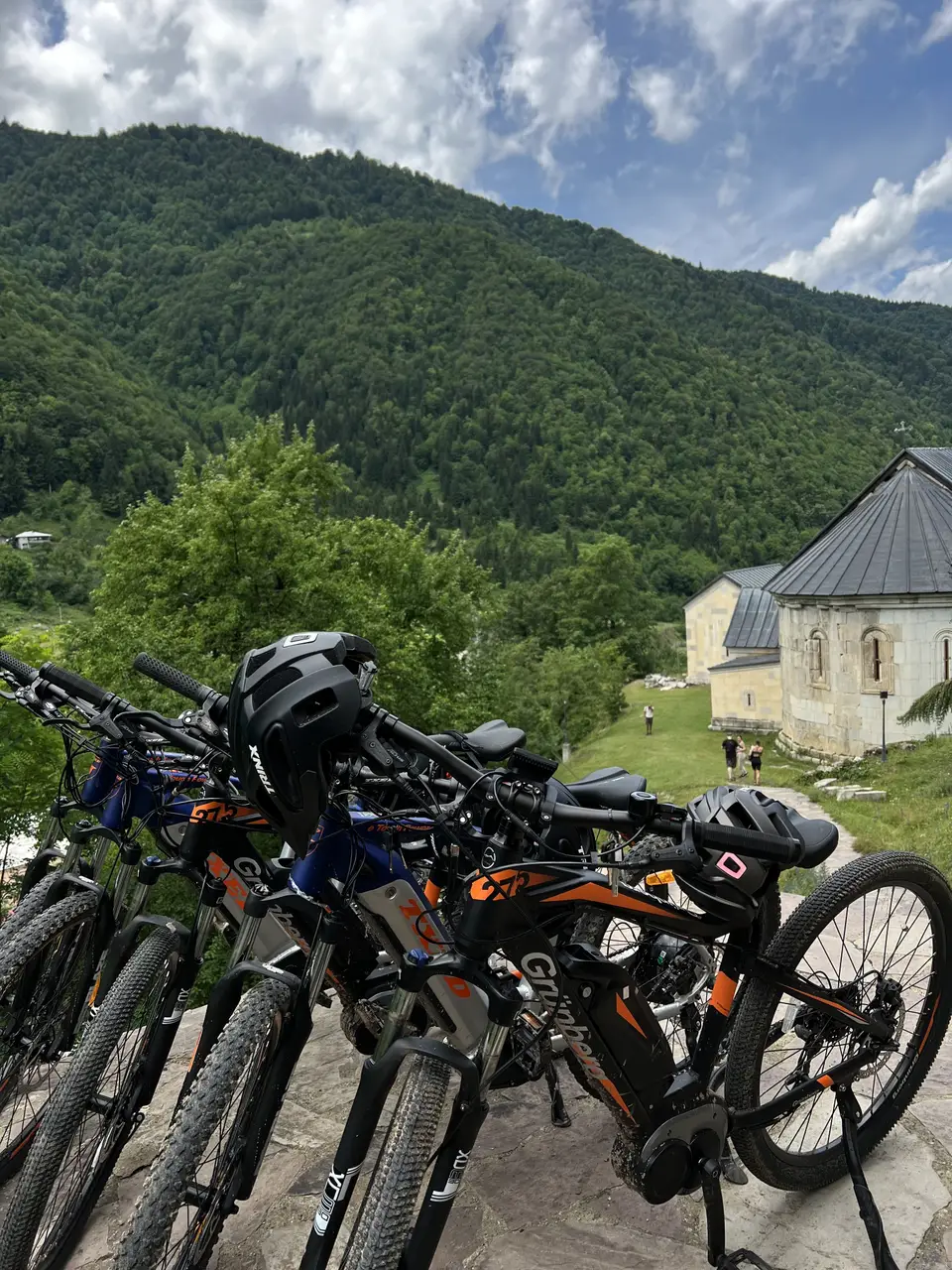E-bikes parked on the path beside Skhalta monastery