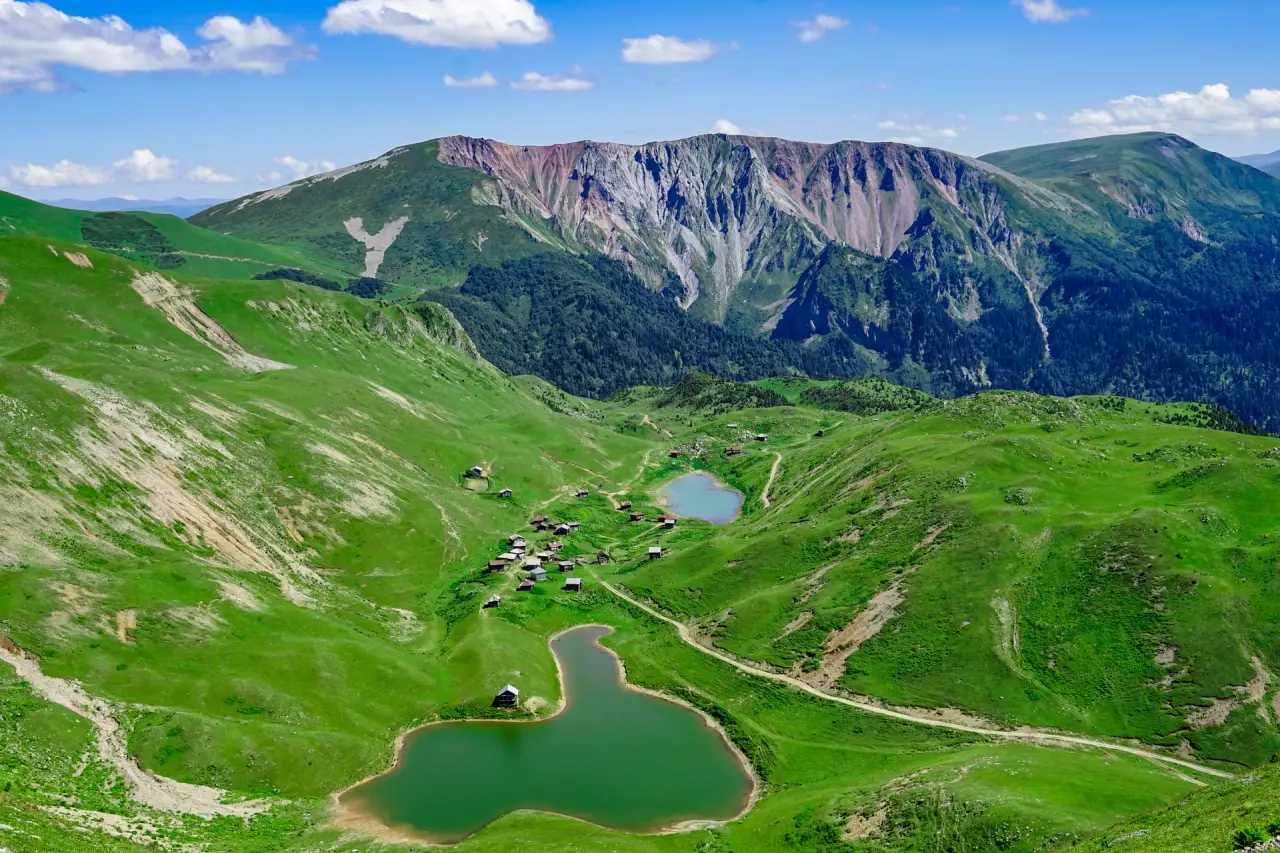 Aerial view of two green Shuamta lakes in a mountain valley