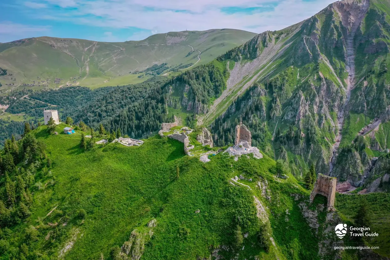 Aerial view of the Khikhani fortress ruins on a green mountain ridge