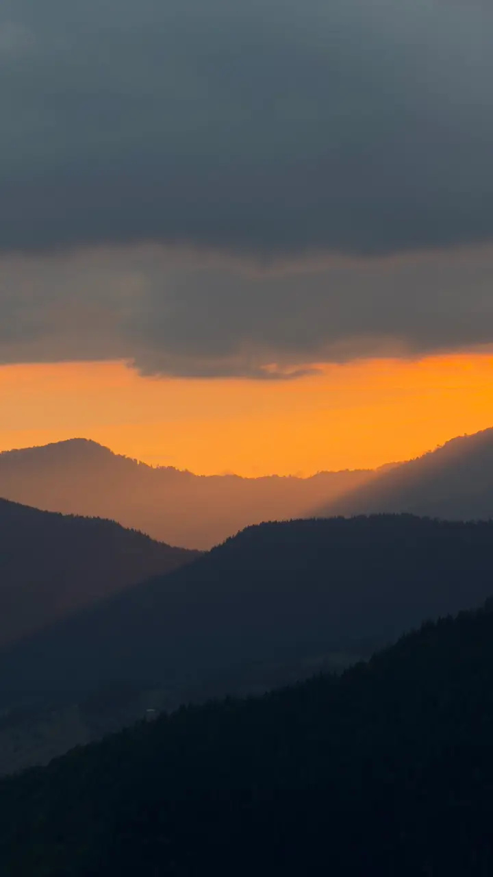 Mountain ridges of Adjara silhouetted against an orange sunset sky